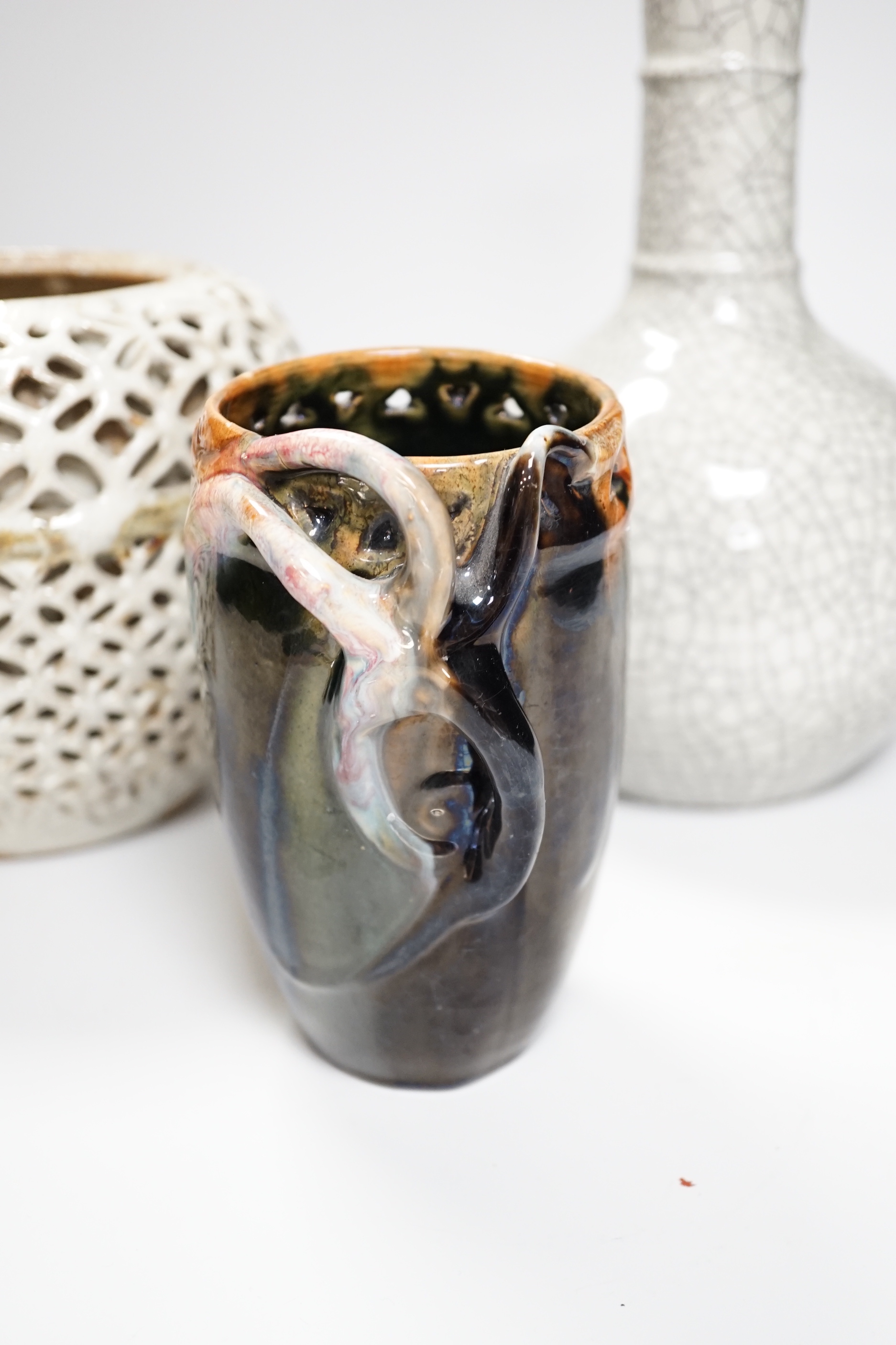 A Chinese crackle glaze bottle vase, a reticulated pottery vase and pottery vase, tallest 23cm high